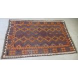 A Kelim rug, decorated with repeating diamond formation designs, on a multi-coloured ground  74" x