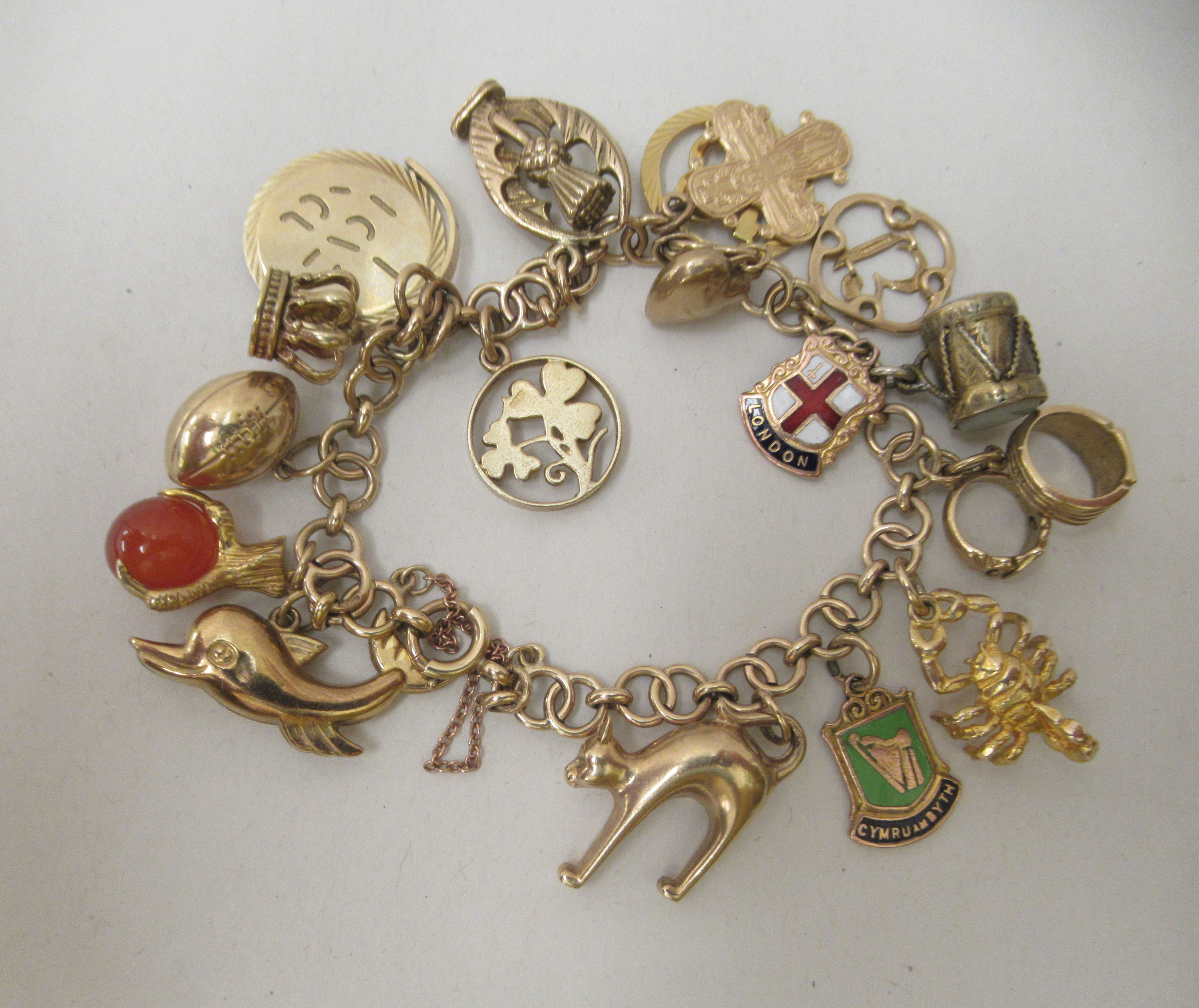 A 9ct gold and yellow metal charm bracelet with various charms - Image 2 of 5