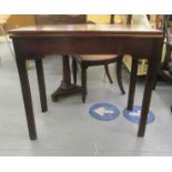 An early 19thC mahogany double gateleg tea table with a foldover top, raised on reeded square