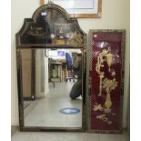 A 20thC black lacquered mirror with an arched crest, decorated in chinoiserie with figures in a