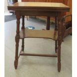 An early 20thC oak card table, the rotating mitred, foldover top enclosing a green baize lined