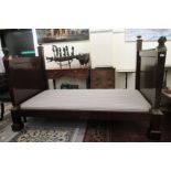 A modern Empire style mahogany finished daybed frame, the ends surmounted by cast metal busts and