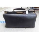 A late Victorian black hide Gladstone bag with lacquered brass fittings 16"w