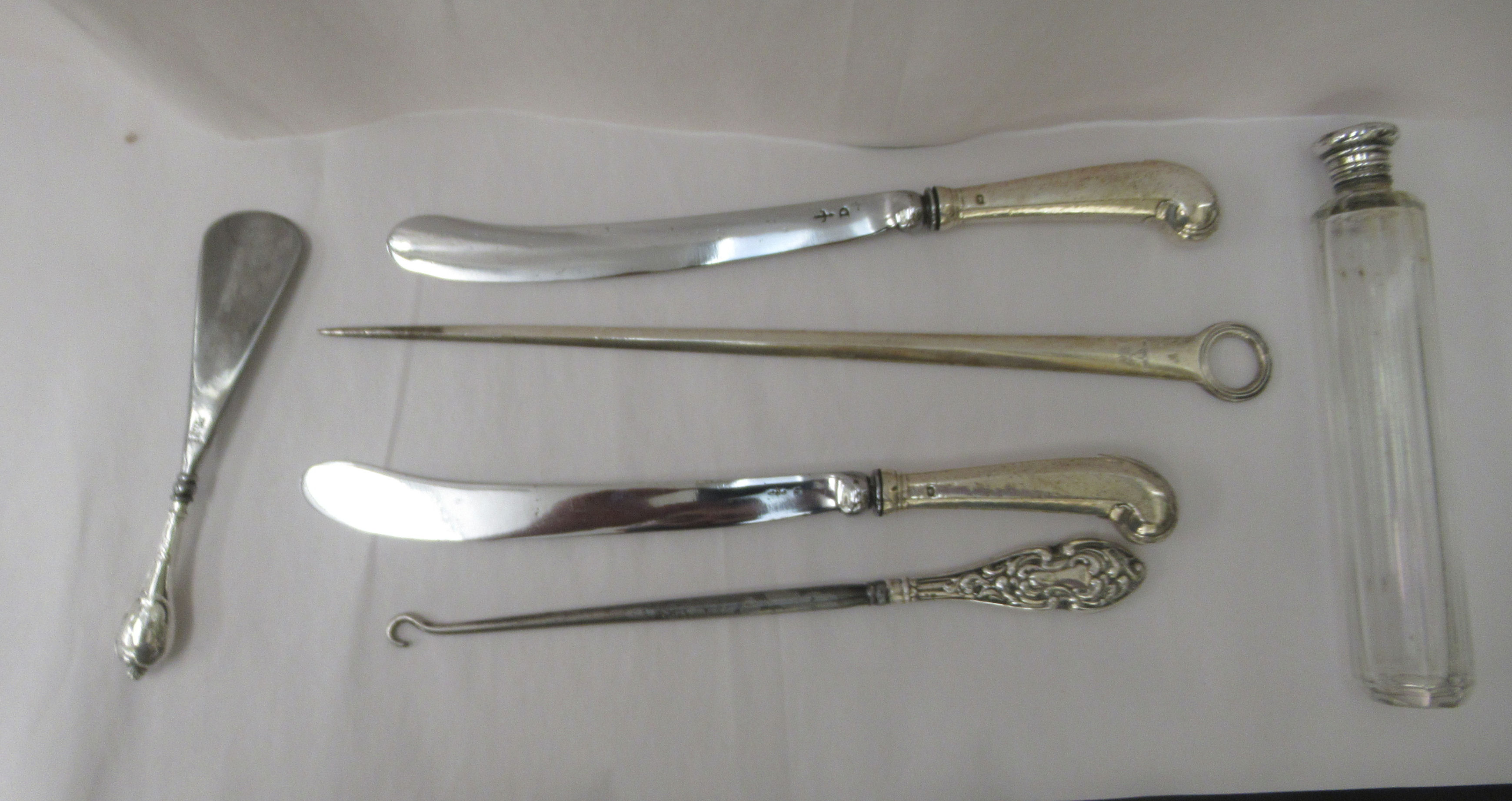 A pair of 19thC silver pistol grip silver table knives;  a 19thC silver skewer with a ring terminal;