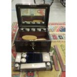 A mid Victorian walnut vanity box with straight sides and a hinged lid, enclosing a removable tray