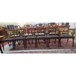 A set of six William IV mahogany framed dining chairs, each with a curved crest and a carved,