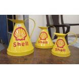 A graduated set of three Shell Oil painted metal jugs  6" - 12"h