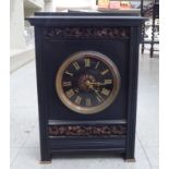 A 1930s black slate cased mantel clock, decorated with fruiting vine ornament; the movement faced by