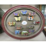 A set of twelve, circa 1987, Franklin Mint porcelain napkin rings from 'The Butterfly Garden' series