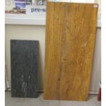 A composition mottled amber coloured marble effect slab  45.5" x 21.5"; and another in black  28.