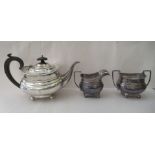 A George V silver three piece tea set  comprising a teapot, a cream jug and sugar basin