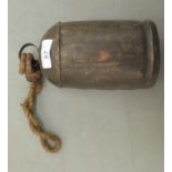 A galvanised metal cow bell, on a rope handle