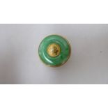 A gold coloured metal and jade set disc brooch, set with a Chinese character  stamped 10