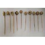 Ten Victorian and later 15ct gold and other stickpins, some set with pearls and white stones