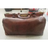 A late Victorian brown hide Gladstone bag with lacquered brass fittings  22"w