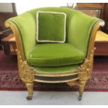 An early 19thC style carved giltwood framed lyre front tub style chair, upholstered in green fabric,