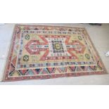 A Souan Kazak rug, decorated in bright colours with repeating stylised designs  82" x 110"