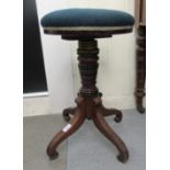 A mid Victorian mahogany piano stool with a revolving tapestry upholstered seat, over a ring