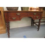 A late 19th/early 20thC mahogany three drawer kneehole dressing table, raised on legs and casters