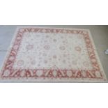 A Caucasian Ziegler rug, decorated with foliate designs, on a cream coloured ground  71" x 95"