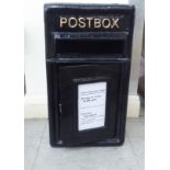 A black painted cast metal post box  17"h  9"w  8"deep
