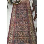A Persian runner, decorated with repeating stylised designs, on a multi-coloured ground  41" x 118"