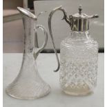 A (possibly) Waterford crystal claret jug with a silver plated collar and handle; and another of