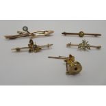 Four dissimilar yellow/gold coloured metal variously set bar brooches; and a tie pin, on a safety