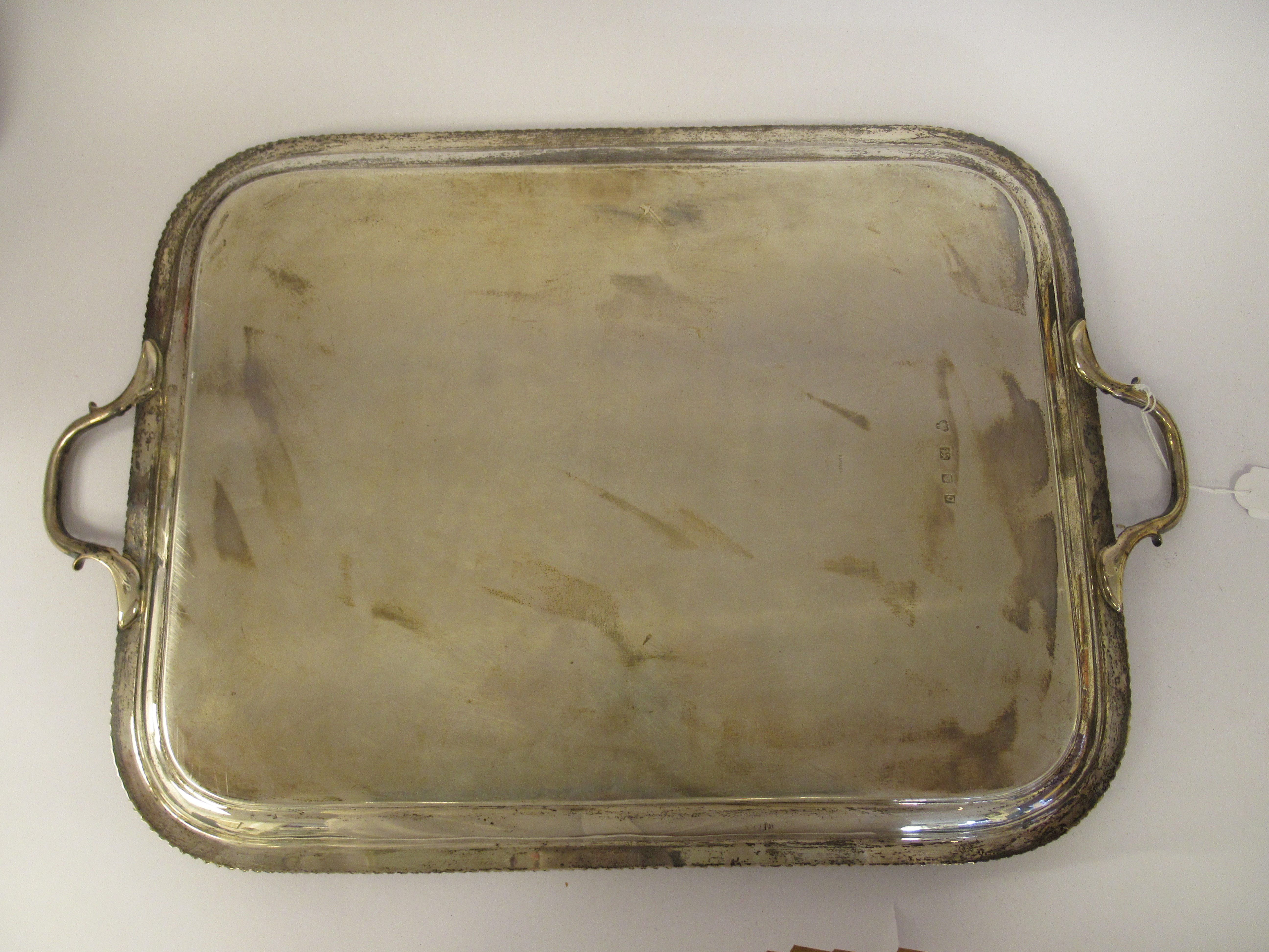 A silver serving tray with a raised gadrooned border and opposing carrying handles  indistinct - Image 4 of 5