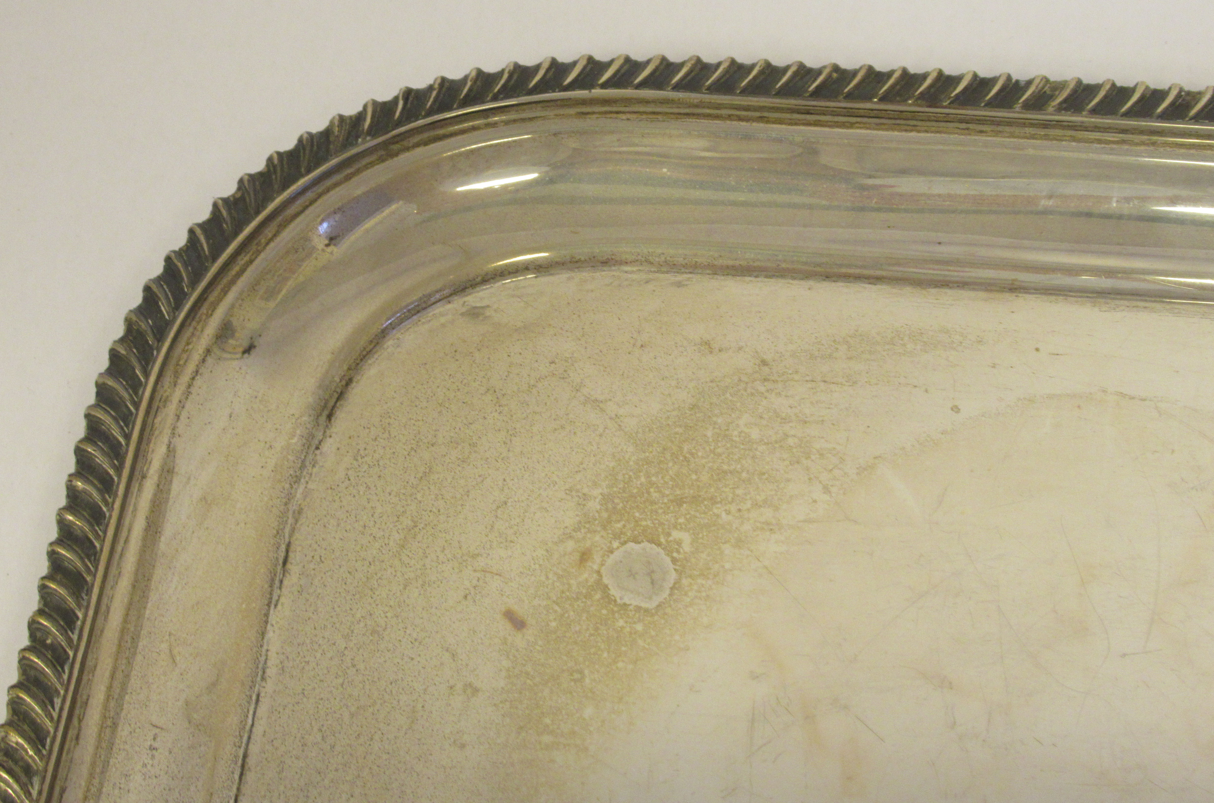 A silver serving tray with a raised gadrooned border and opposing carrying handles  indistinct - Image 3 of 5