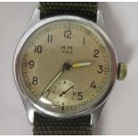 A 1940s Cal 720 KM stainless steel cased military wristwatch, faced by an Arabic dial, on a webbing