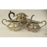 A three piece Sterling silver tea set of oval, demi-reeded form  comprising a teapot with bead