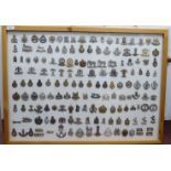 A framed presentation of approx one hundred and fifty military cap and other badges, some copies: to