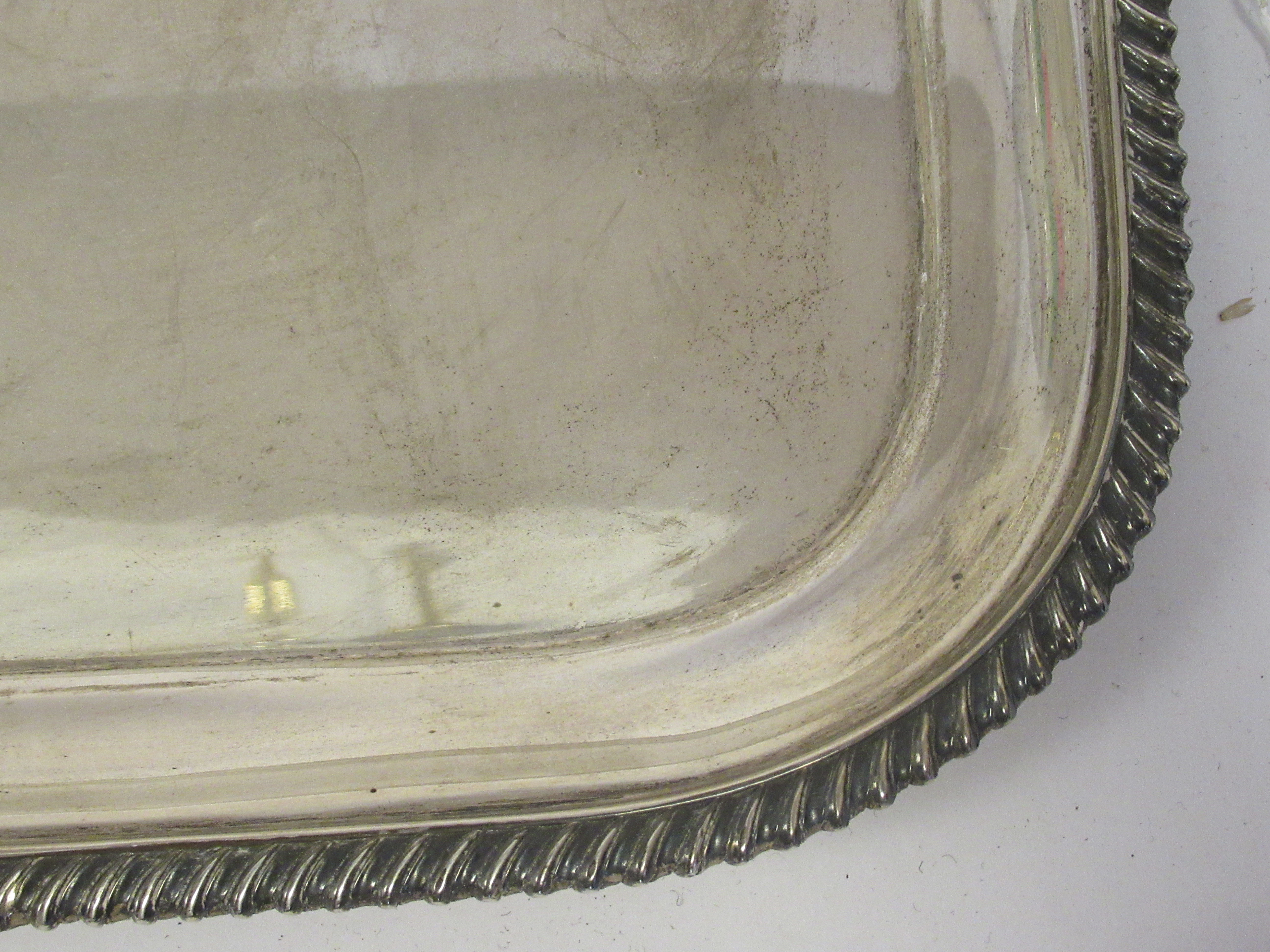 A silver serving tray with a raised gadrooned border and opposing carrying handles  indistinct - Image 2 of 5