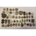 Approx. fifty, mainly Welsh related military cap badges and associated insignia, some copies: to