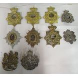 Ten regimental helmet plates, some copies: to include 63rd, 97th, 99th and 8th  (Please Note: this