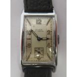 An Art Deco Doxa chromium plated cased wristwatch, faced by a rectangular Arabic and baton dial,