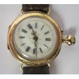 A ladies, circa 1900, engraved gold coloured metal cased wristwatch (converted from a fob watch)
