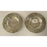 A pair of late 19th/early 20thC Dutch silver coloured metal dishes, the wide, raised borders with