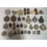 Approx thirty regimental cap badges, helmet plates and associated insignia, some copies: to