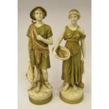 A pair of Royal Dux Art Nouveau biscuit glazed, painted and gilded porcelain standing figures, a