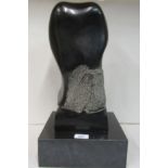 A modern, possibly Danish, carved black stone freeform sculpture, on a plinth  17.75”h overall
