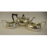 A three piece silver tea set of oval ogee form with applied wire rims  comprising a teapot, having