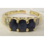 A 14ct gold three stone, claw set sapphire and diamond ring