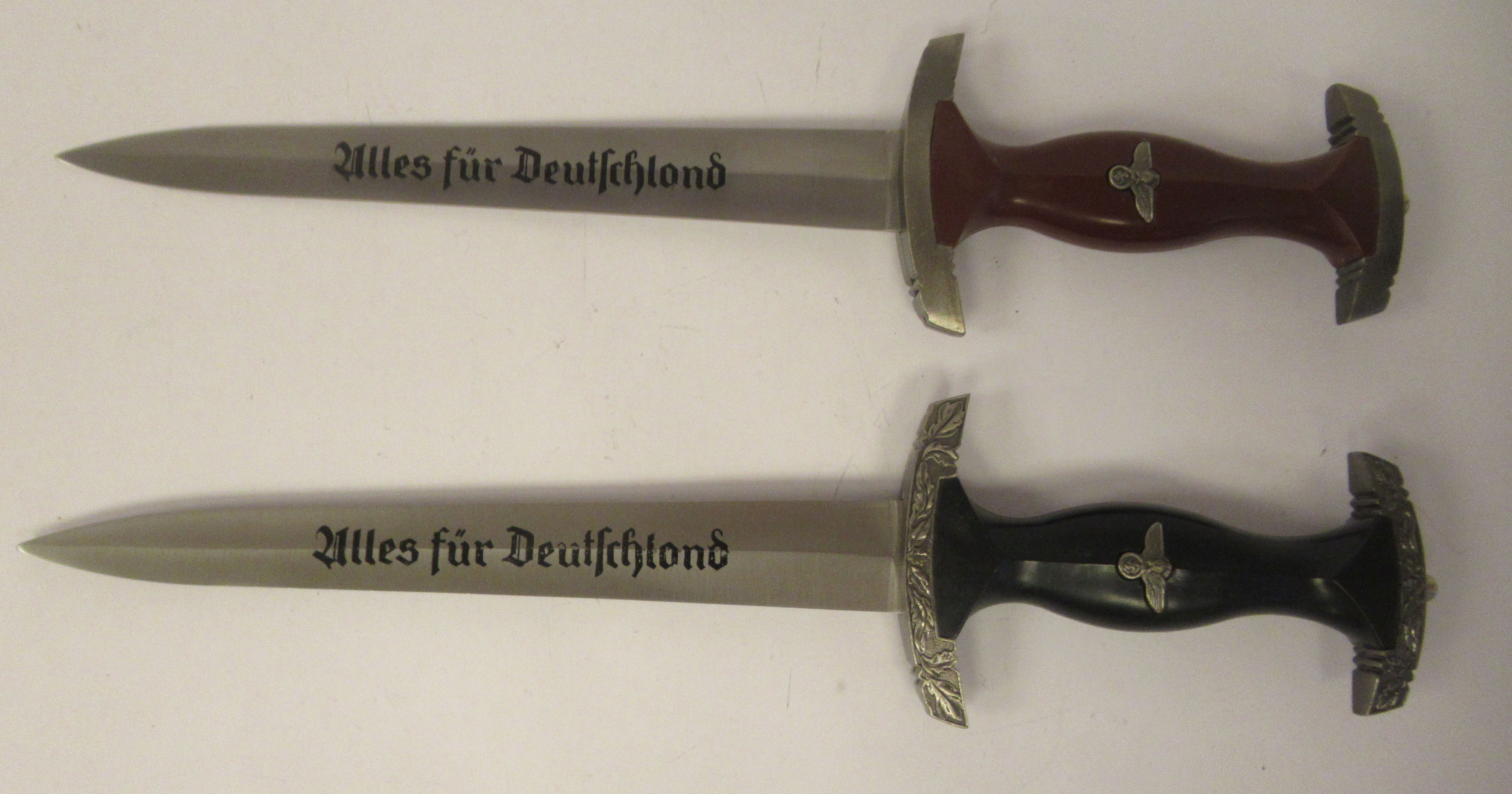 Four replica Third Reich era bladed weapons, viz. a Hitler Youth dagger, in a steel sheath; two - Image 3 of 4