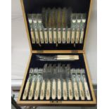 A cased set of twelve Butler of Sheffield knives and forks with ivorine handles and silver ferrules,