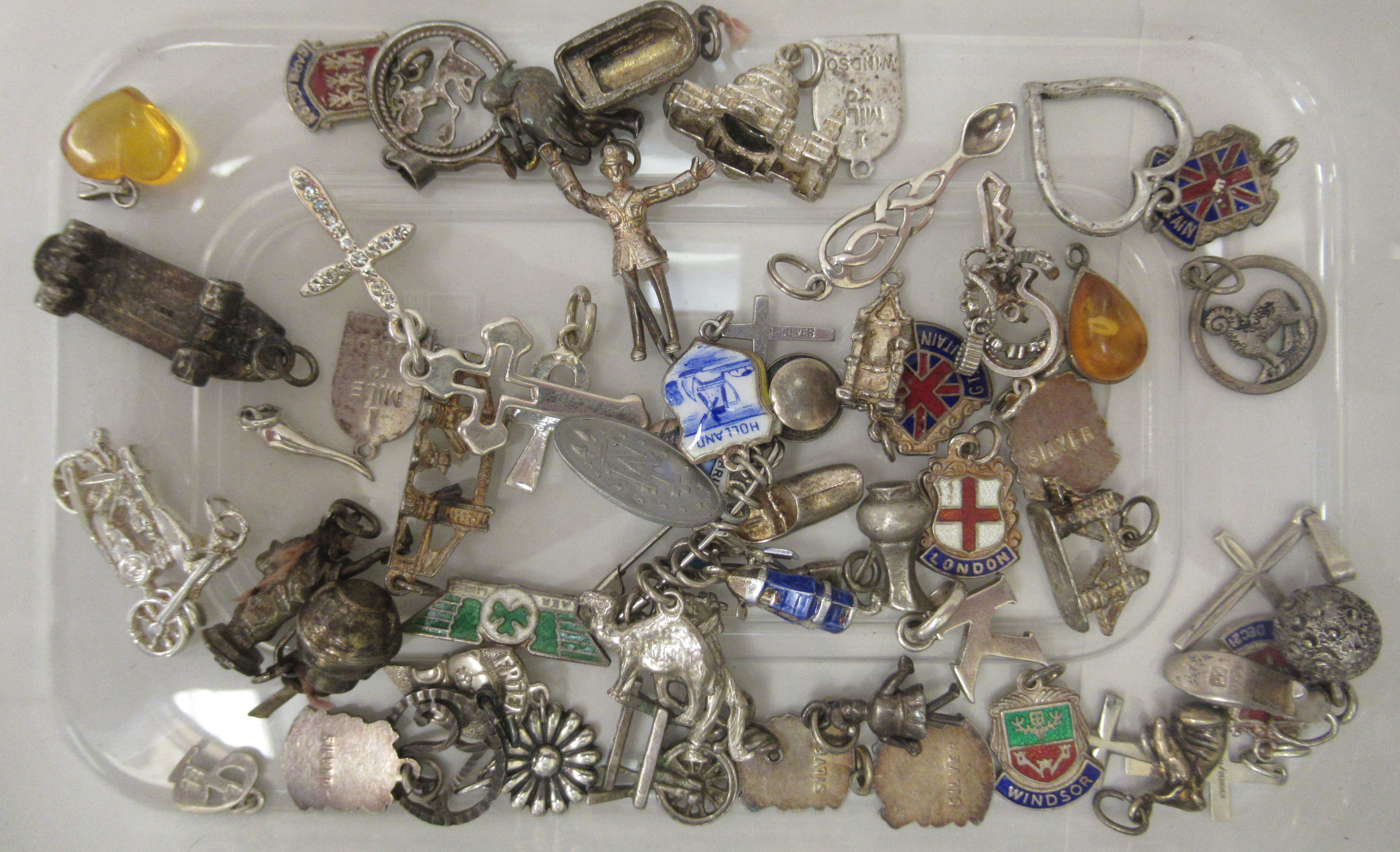 Silver and white metal bracelet charms: to include a camel, a shoe and a crucifix