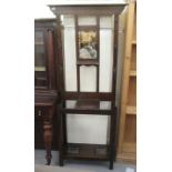 A 1930s stained oak hallstand, having a mirrored top with six hooks, over two opposing umbrella/