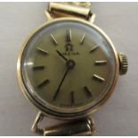 A ladies Omega 9ct gold cased wristwatch, faced by a baton dial