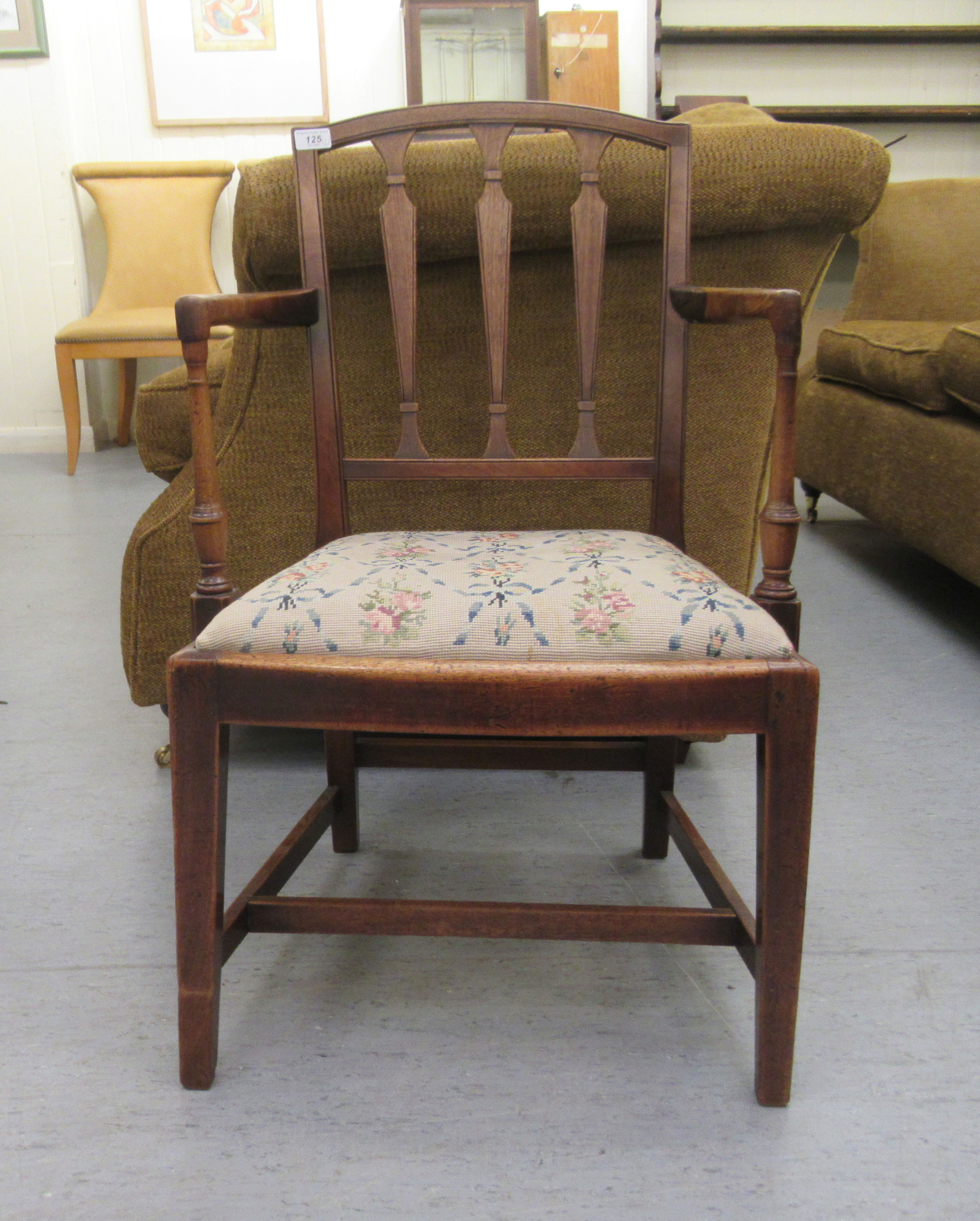 An early 20thC Georgian design mahogany framed open arm chair, the tapestry covered drop-in seat